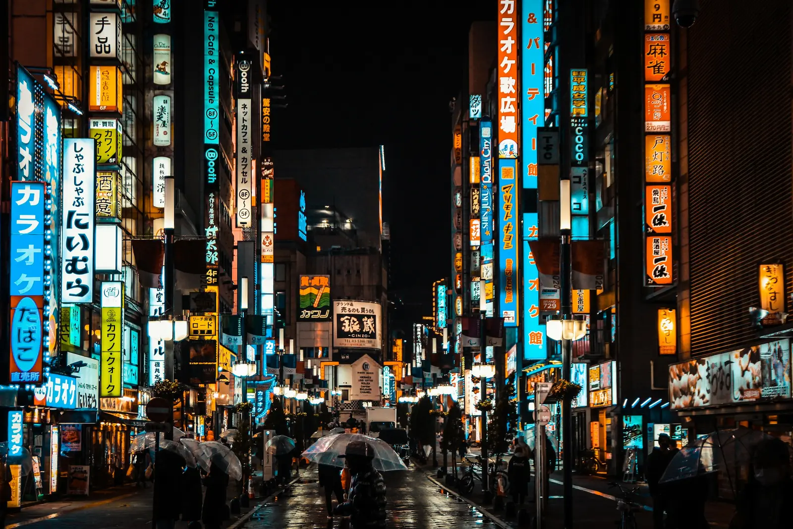 The Shibuya crossing at dusk with lit screens and pedestrians